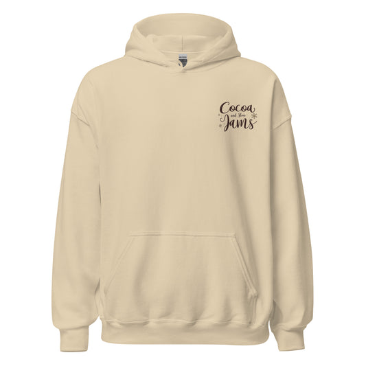 “Cocoa and Slow Jams Cozy Hoodie – cream unisex hoodie with cocoa-brown logo, perfect for holiday comfort”